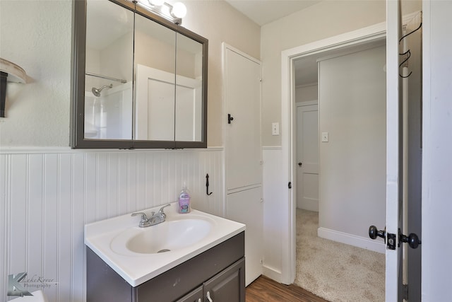 bathroom featuring vanity, wood-type flooring, and walk in shower