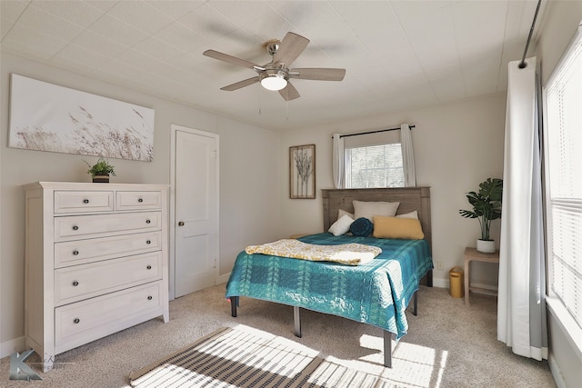 bedroom featuring light colored carpet and ceiling fan