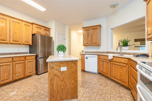 kitchen featuring white appliances, crown molding, sink, light tile patterned floors, and a center island