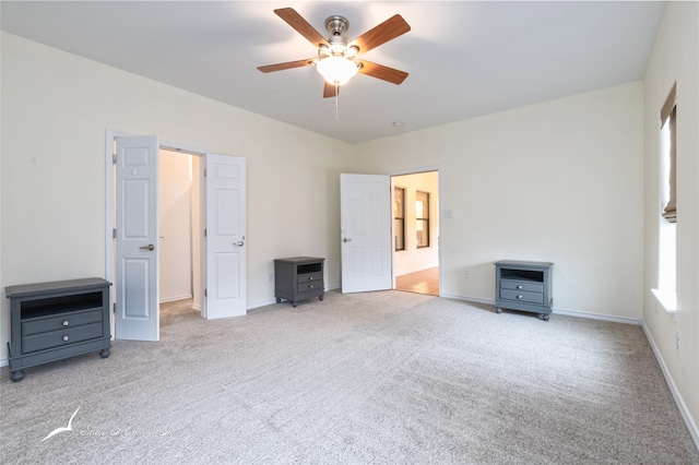 unfurnished bedroom featuring ceiling fan and light carpet