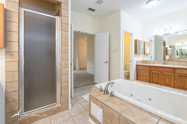 full bathroom featuring tile patterned floors, vanity, toilet, and shower with separate bathtub