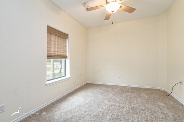 empty room featuring light carpet and ceiling fan