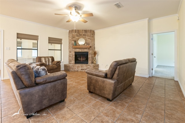 tiled living room featuring a brick fireplace, ceiling fan, and ornamental molding