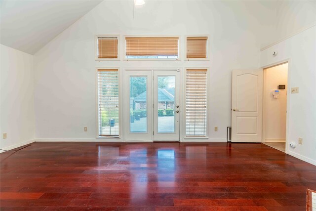 empty room featuring dark hardwood / wood-style flooring and high vaulted ceiling