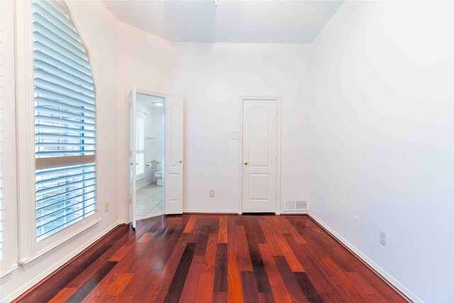 empty room featuring dark hardwood / wood-style flooring