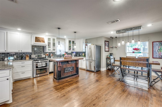 kitchen featuring white cabinetry, a center island, and appliances with stainless steel finishes