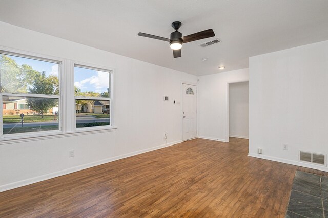 spare room featuring ceiling fan and dark hardwood / wood-style flooring