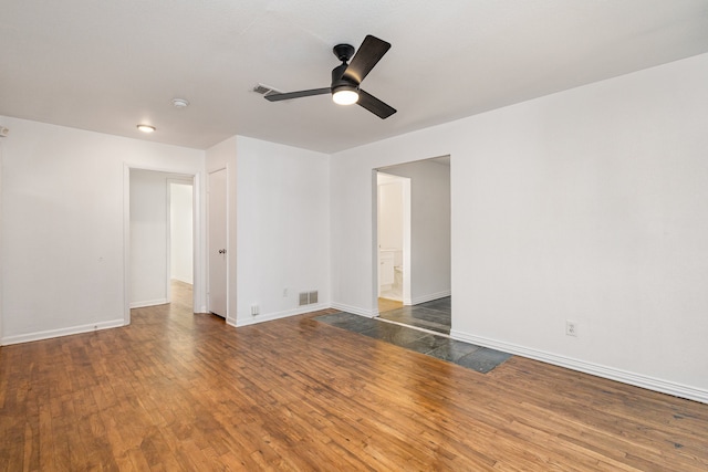 empty room featuring ceiling fan and dark hardwood / wood-style flooring