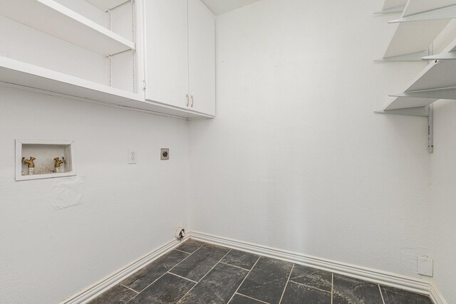 clothes washing area with hookup for an electric dryer, cabinets, and washer hookup