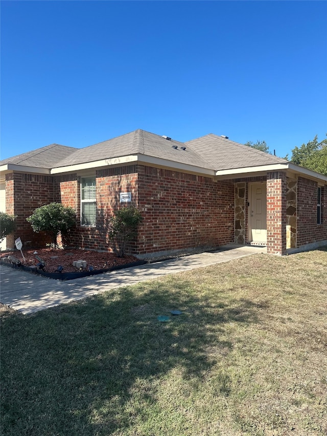 view of side of property with a lawn