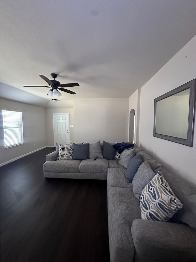 living room with dark hardwood / wood-style floors and ceiling fan