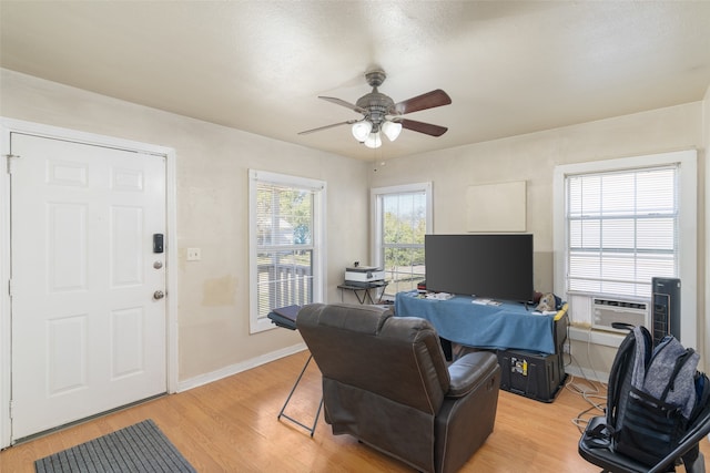 office space with ceiling fan, light hardwood / wood-style floors, and cooling unit