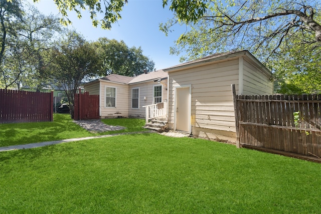 rear view of property with a lawn