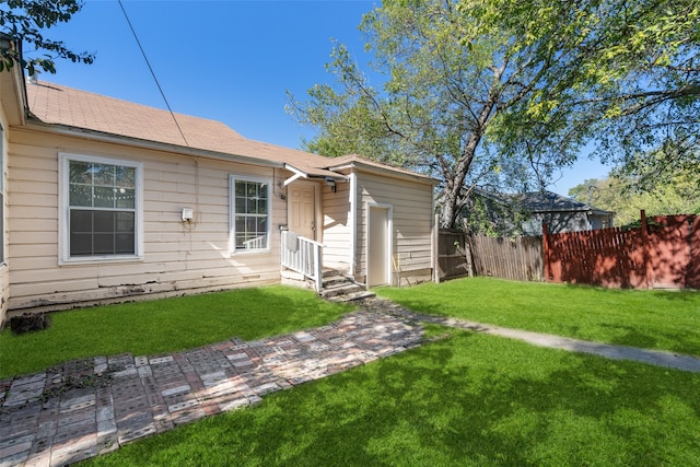 rear view of house featuring a lawn