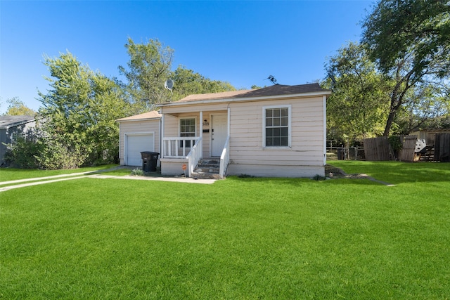 view of front of home featuring a front yard, a porch, and a garage