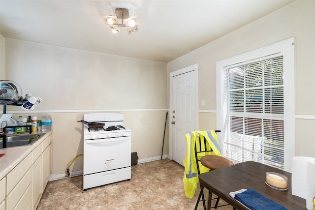 kitchen featuring white gas range and sink