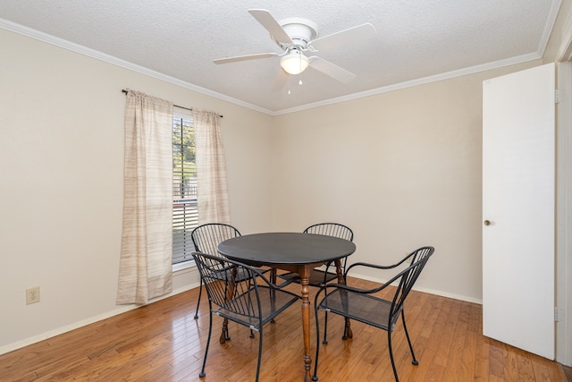 dining area featuring ceiling fan, wood-type flooring, and crown molding