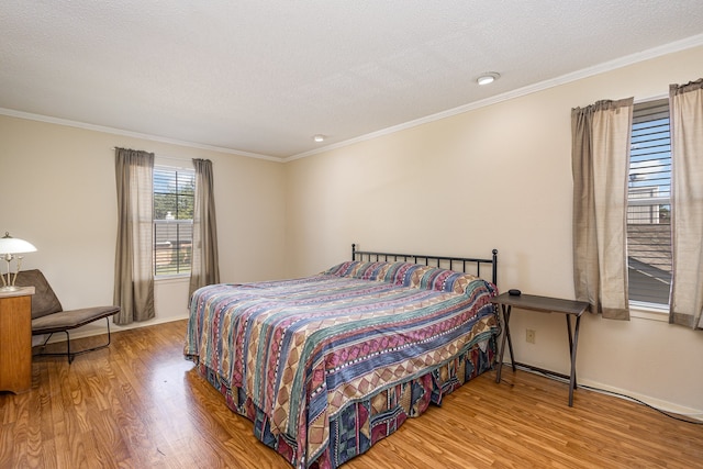 bedroom featuring a textured ceiling, crown molding, and light hardwood / wood-style flooring