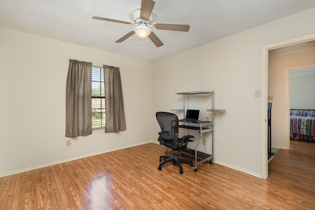 office area with ceiling fan, light hardwood / wood-style floors, and a textured ceiling