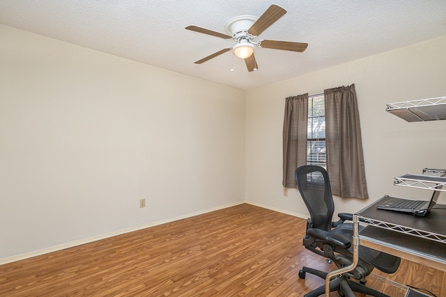 office featuring ceiling fan, wood-type flooring, and a textured ceiling