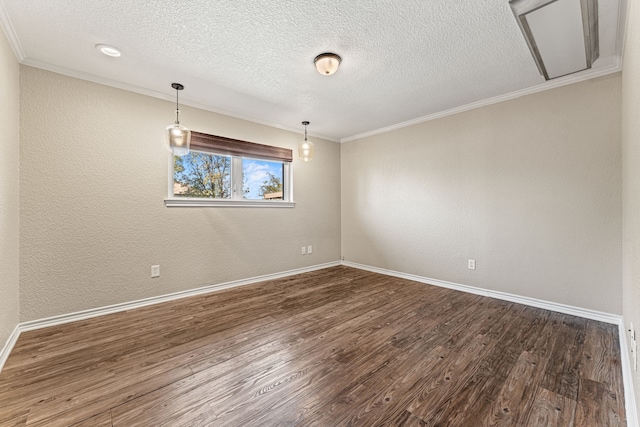 spare room with a textured ceiling, dark hardwood / wood-style floors, and crown molding