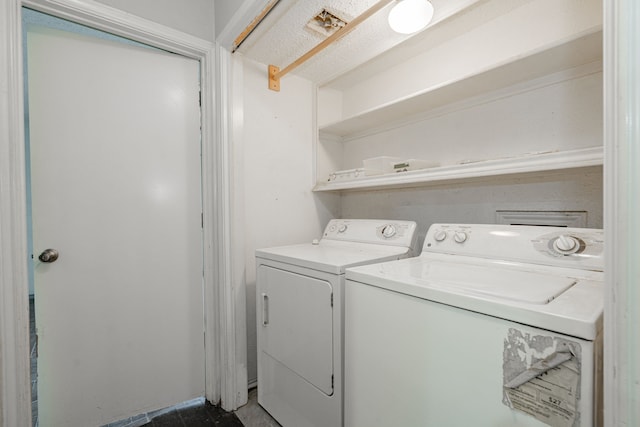 clothes washing area with washer and clothes dryer