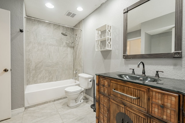 full bathroom featuring tile patterned floors, vanity, toilet, and tiled shower / bath