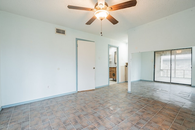 spare room with a textured ceiling and ceiling fan