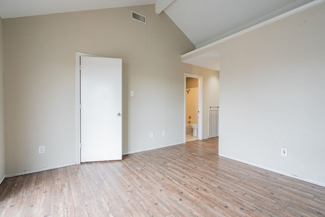 spare room featuring beamed ceiling, high vaulted ceiling, and light wood-type flooring