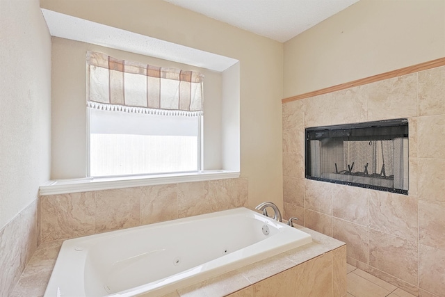 bathroom with tile patterned flooring, a relaxing tiled tub, and tile walls