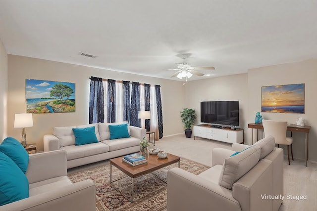 carpeted living room with ceiling fan