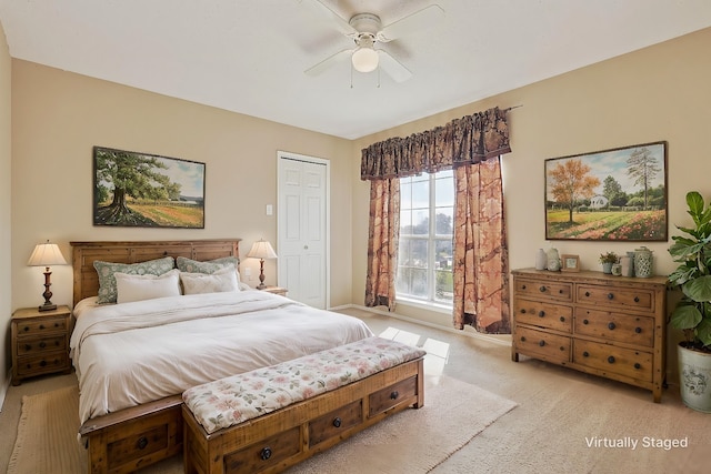 bedroom featuring ceiling fan, light carpet, and a closet