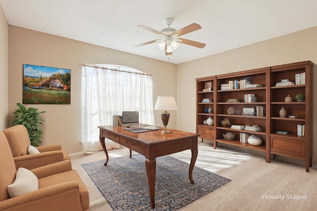 carpeted office with ceiling fan and a textured ceiling