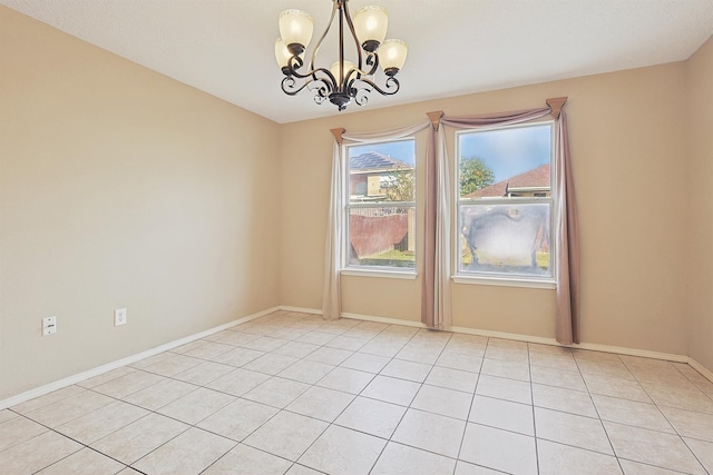 tiled empty room featuring a chandelier