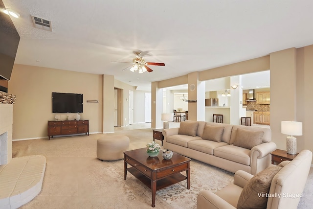 carpeted living room featuring ceiling fan