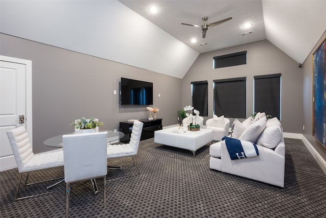 living room featuring ceiling fan, lofted ceiling, and dark colored carpet