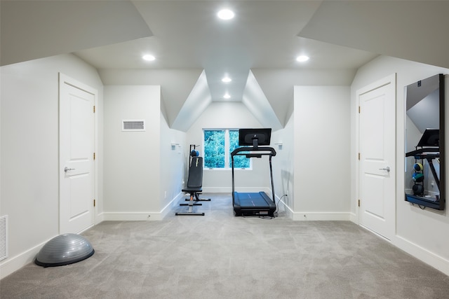 workout room featuring light colored carpet and lofted ceiling