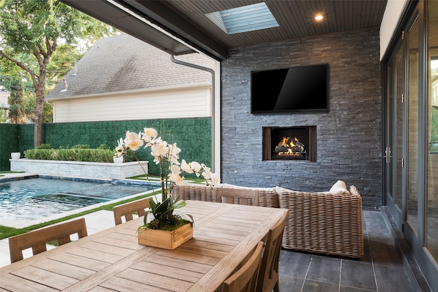 exterior space with a fenced in pool and an outdoor stone fireplace