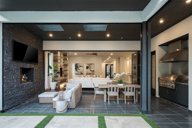 living room featuring an outdoor stone fireplace