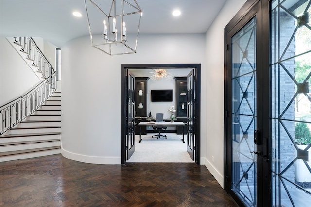 entryway with a wealth of natural light, french doors, and parquet flooring