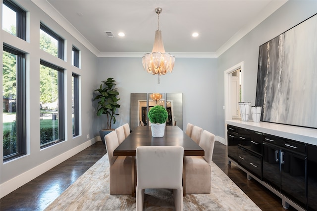 dining room featuring a chandelier, ornamental molding, and dark wood-type flooring