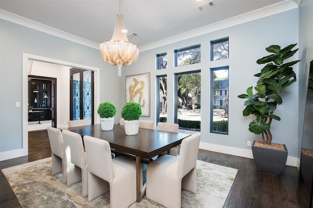 dining room with a notable chandelier, ornamental molding, and dark wood-type flooring