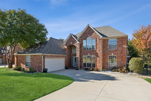 view of property featuring a front lawn and a garage