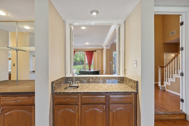 interior space with a textured ceiling, hardwood / wood-style flooring, and sink