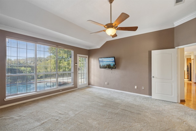 empty room featuring ceiling fan, crown molding, light colored carpet, and lofted ceiling