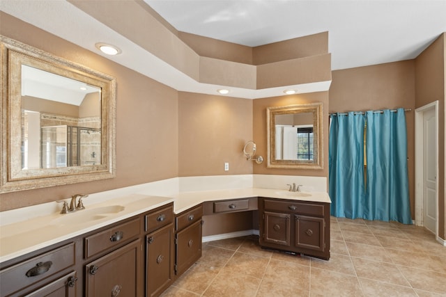 bathroom with tile patterned flooring, vanity, a wealth of natural light, and a shower with shower door