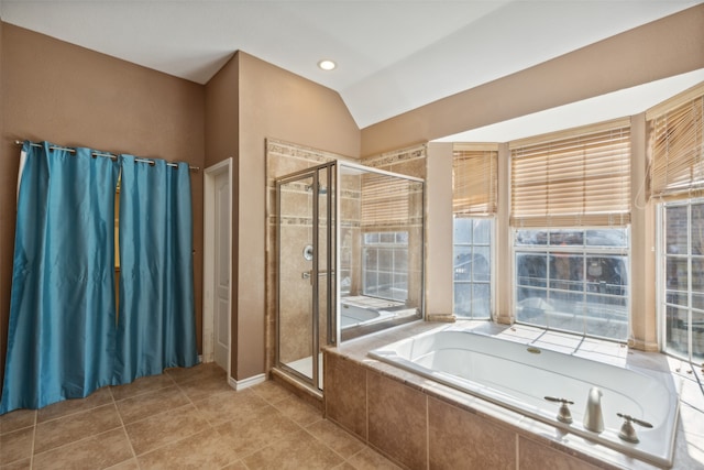 bathroom with tile patterned flooring, lofted ceiling, shower with separate bathtub, and a wealth of natural light