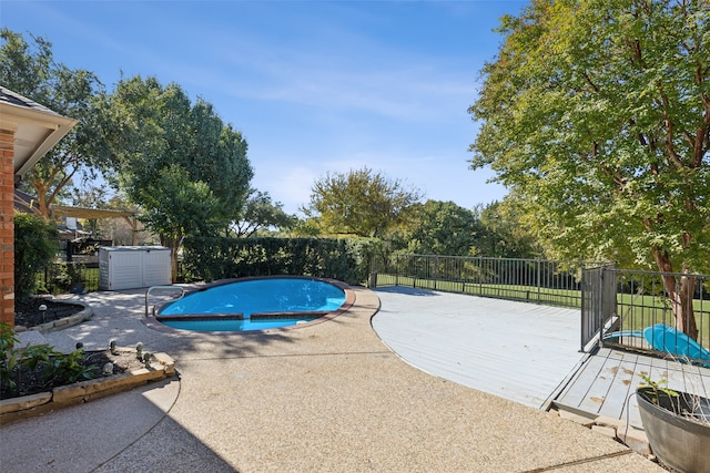 view of swimming pool with a patio area and a deck