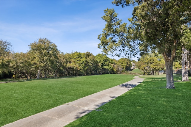 view of property's community featuring a yard