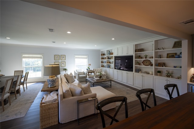 living room with crown molding and dark wood-type flooring